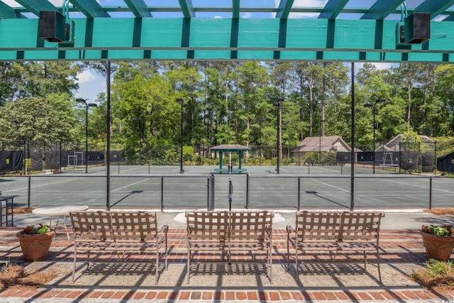 view of sport court featuring fence