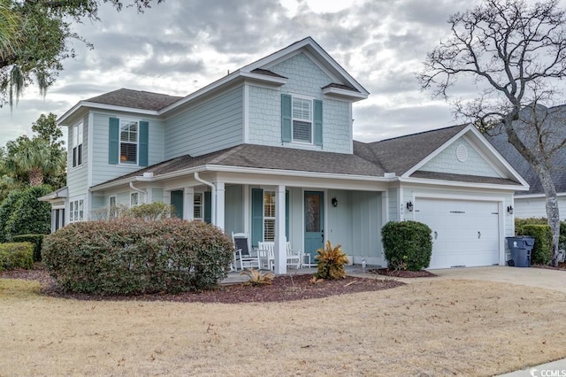 view of front of house with a garage, driveway, a porch, and a shingled roof