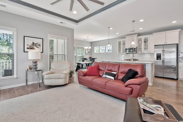 living area featuring light wood finished floors, a wealth of natural light, and recessed lighting