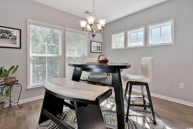 dining area featuring baseboards, visible vents, a wealth of natural light, and wood finished floors