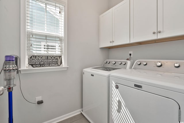 laundry room with separate washer and dryer, cabinet space, and baseboards