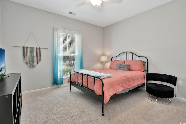 carpeted bedroom featuring baseboards, visible vents, and ceiling fan