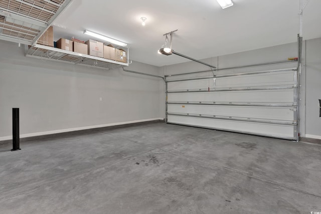 garage with a garage door opener and baseboards