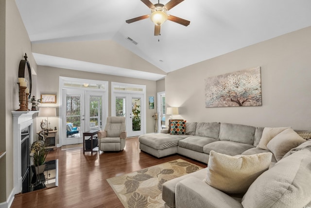 living room with high vaulted ceiling, ceiling fan, visible vents, a fireplace, and wood finished floors