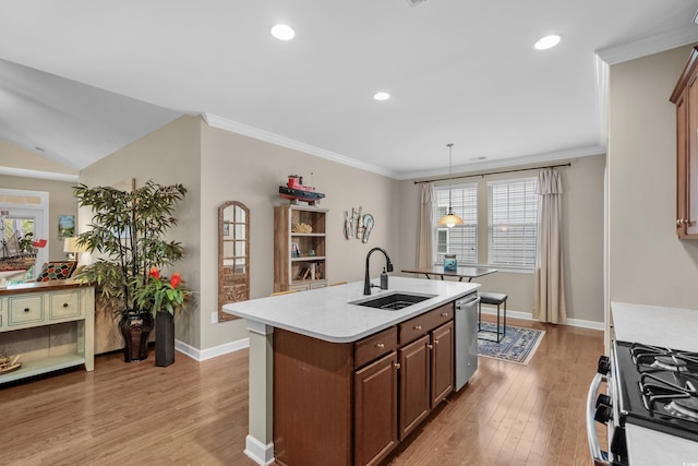 kitchen featuring a sink, light wood-style floors, light countertops, dishwasher, and gas range oven