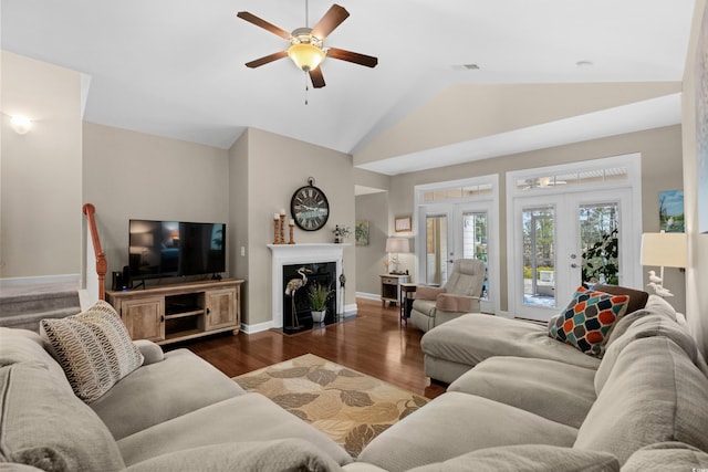 living room featuring a premium fireplace, baseboards, visible vents, ceiling fan, and wood finished floors