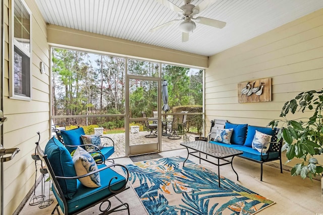 sunroom / solarium featuring ceiling fan