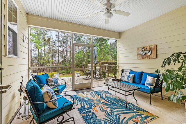 sunroom / solarium with outdoor dining area, an outdoor living space, and ceiling fan