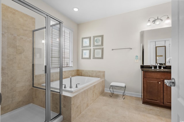 bathroom featuring tile patterned flooring, vanity, a bath, and a shower stall