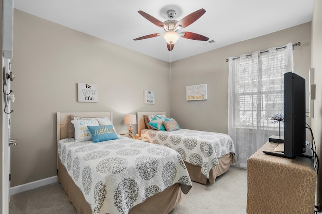 bedroom featuring light carpet, ceiling fan, visible vents, and baseboards