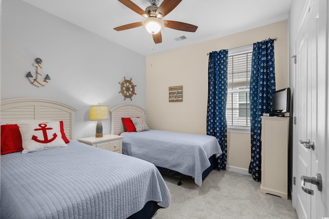 bedroom with a ceiling fan, baseboards, light colored carpet, and visible vents
