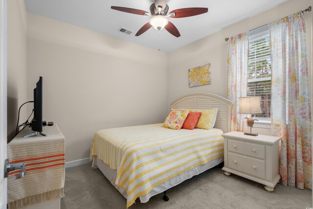 bedroom featuring light carpet, baseboards, visible vents, and a ceiling fan