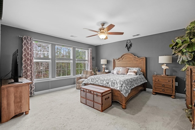 bedroom featuring baseboards, carpet floors, visible vents, and a ceiling fan