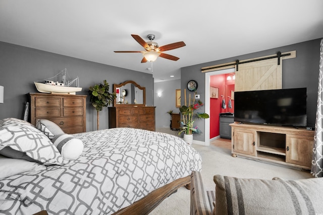 bedroom with a barn door, baseboards, a ceiling fan, and light colored carpet