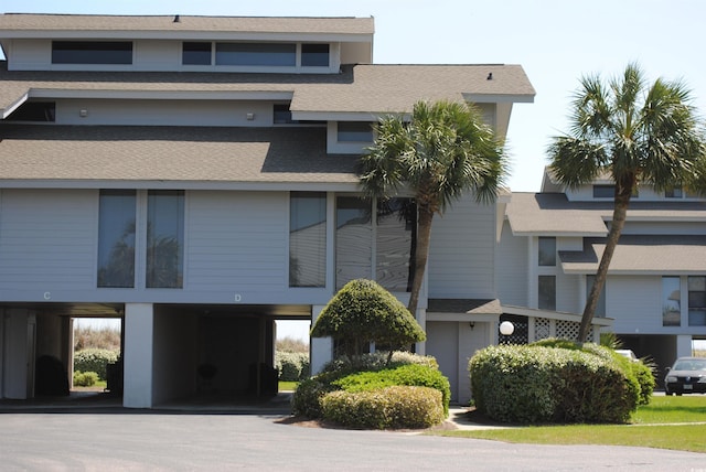 view of property featuring a carport and driveway