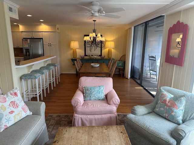 living room featuring ceiling fan with notable chandelier, visible vents, wood finished floors, and recessed lighting