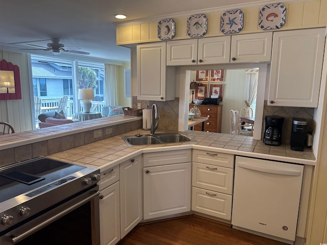 kitchen featuring tile countertops, white dishwasher, a sink, white cabinets, and stainless steel electric range