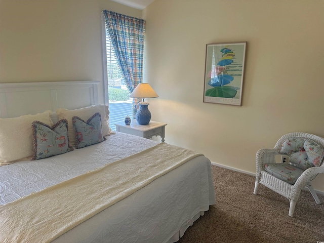 bedroom with carpet and baseboards