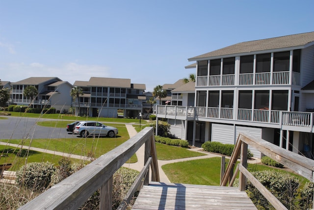 view of property's community featuring a residential view and a lawn