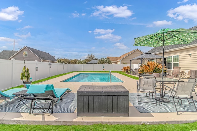 view of swimming pool featuring a fenced in pool, a patio, and a fenced backyard