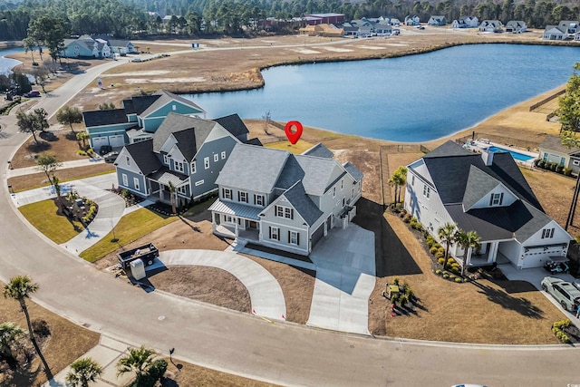 drone / aerial view featuring a residential view and a water view