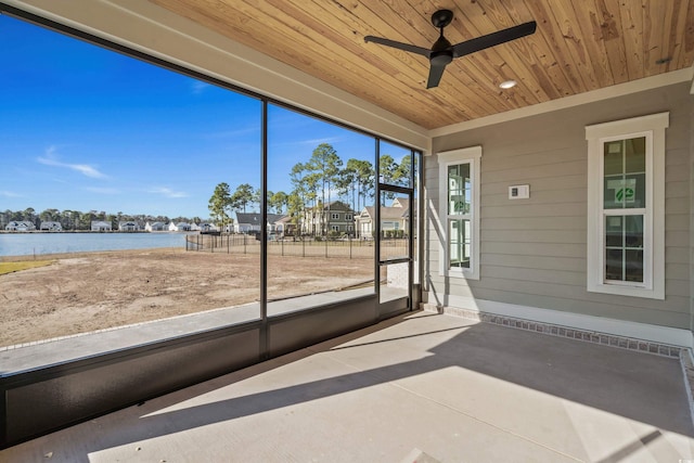 unfurnished sunroom with wooden ceiling, a water view, and ceiling fan