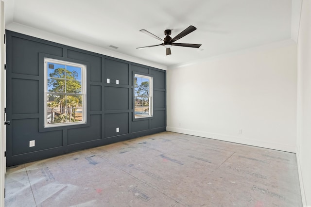 interior space with a ceiling fan, visible vents, a decorative wall, and baseboards