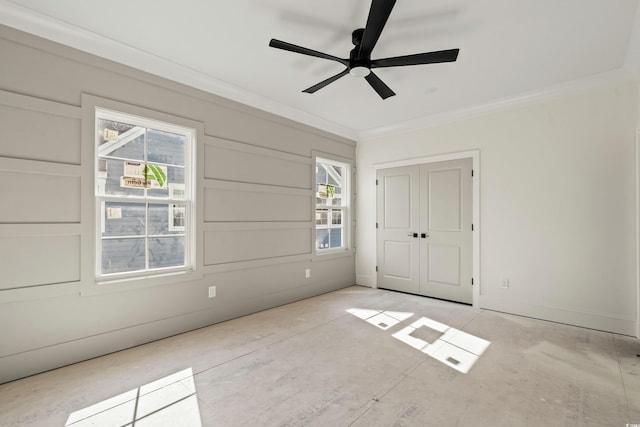 unfurnished bedroom with baseboards, ceiling fan, a closet, and crown molding