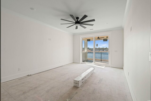 spare room with ceiling fan, baseboards, and crown molding