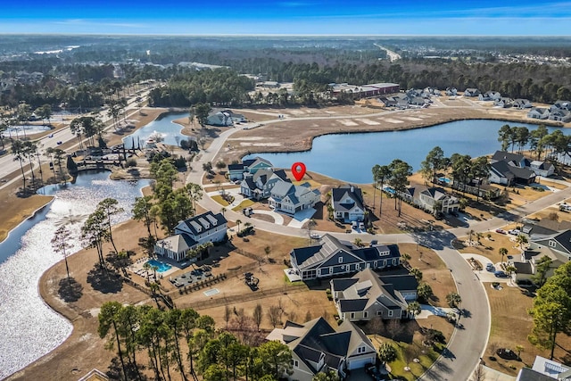 birds eye view of property featuring a water view and a residential view