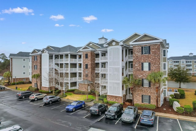 view of building exterior with uncovered parking