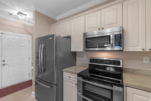 kitchen with appliances with stainless steel finishes, light countertops, ornamental molding, and light tile patterned floors