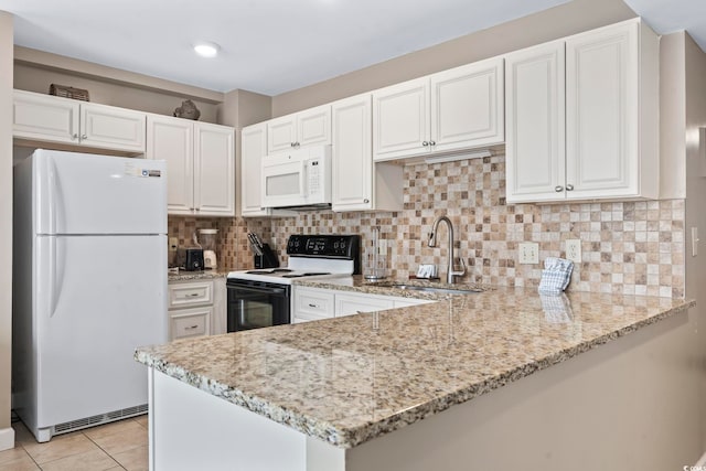 kitchen with white appliances, light tile patterned floors, light stone counters, and a sink