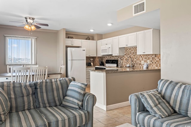 living room with light tile patterned floors, visible vents, and a ceiling fan