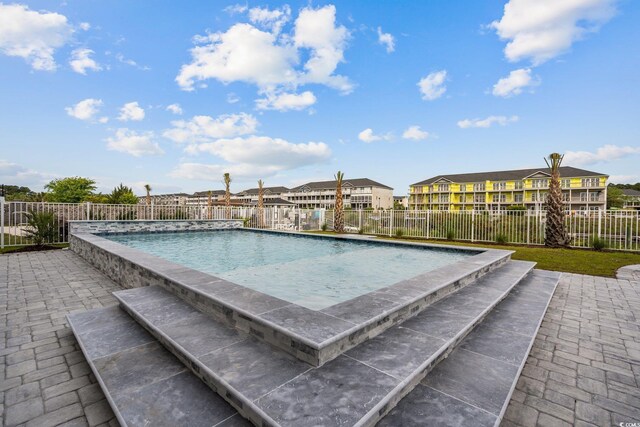 view of swimming pool with a fenced in pool, a patio, and fence