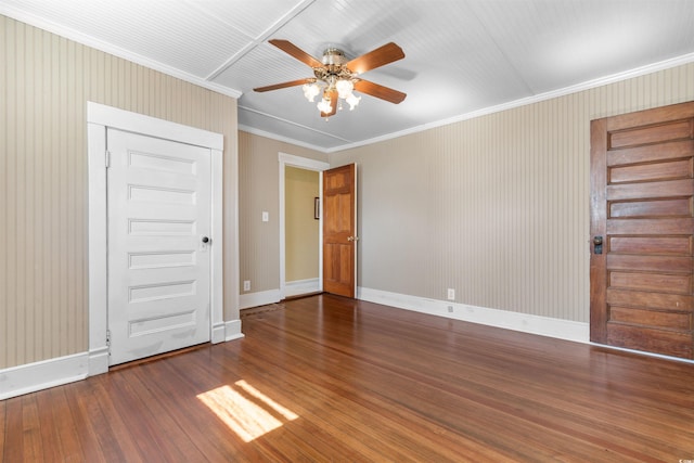 empty room featuring baseboards, ceiling fan, hardwood / wood-style floors, and crown molding