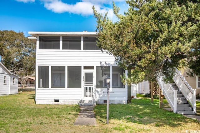 view of front facade featuring a sunroom, a front yard, and crawl space