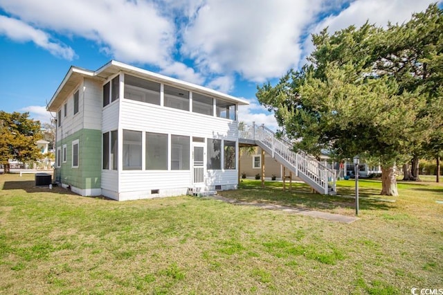 back of house with a yard, stairway, crawl space, and a sunroom