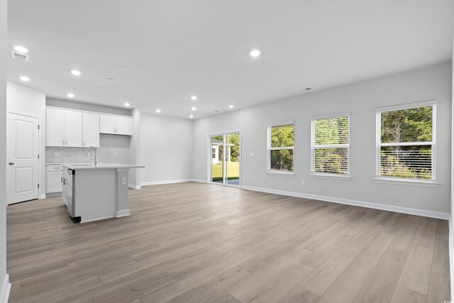 2104 Copper Creek Ct, Longs, SC 29568 - unfurnished living room featuring visible vents, a sink, recessed lighting, light wood finished floors, and baseboards
