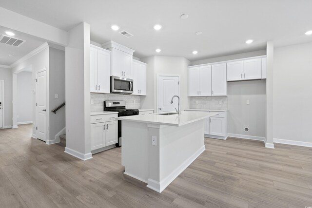 2104 Copper Creek Ct, Longs, SC 29568 - kitchen with a sink, stainless steel appliances, visible vents, and white cabinets