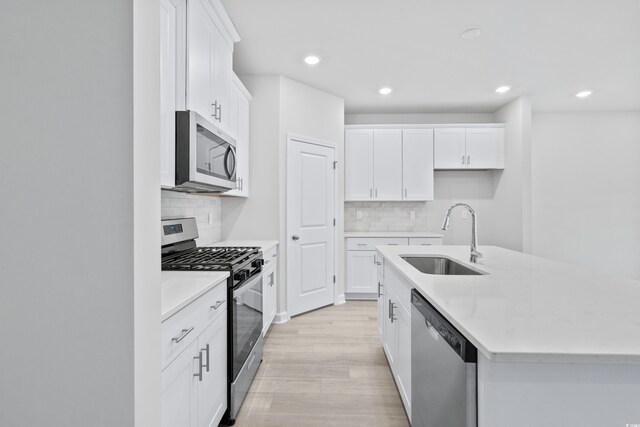 2104 Copper Creek Ct, Longs, SC 29568 - kitchen with appliances with stainless steel finishes, white cabinetry, an island with sink, and a sink