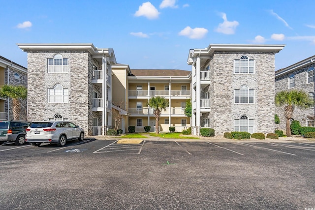 view of building exterior with uncovered parking