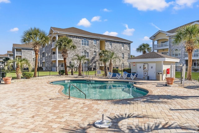 pool featuring a patio and fence