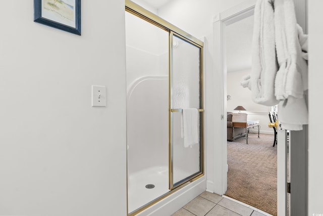 bathroom with tile patterned floors and a stall shower