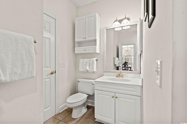 bathroom featuring baseboards, toilet, vanity, and tile patterned flooring