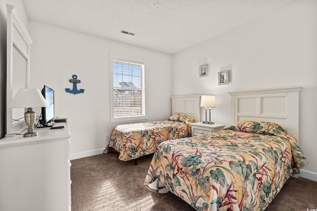 bedroom featuring visible vents, a textured ceiling, and baseboards