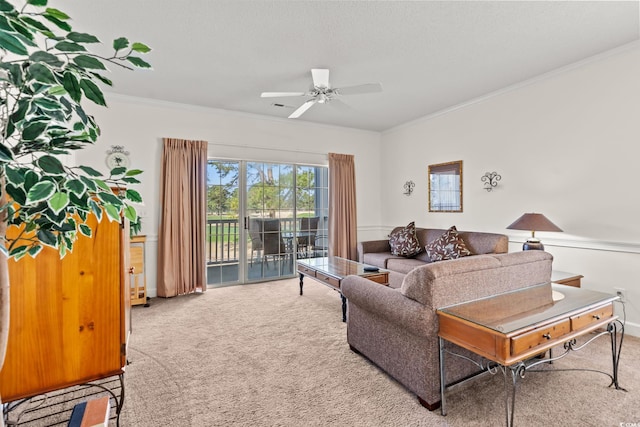 living area featuring ceiling fan, carpet, and ornamental molding