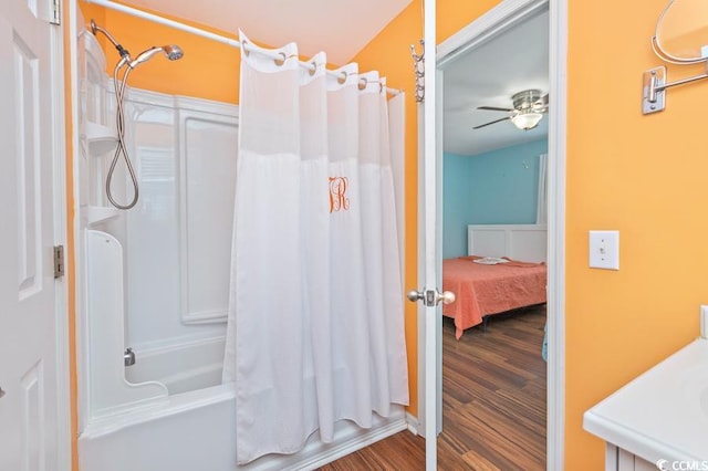 bathroom featuring shower / bath combination with curtain, a ceiling fan, and wood finished floors