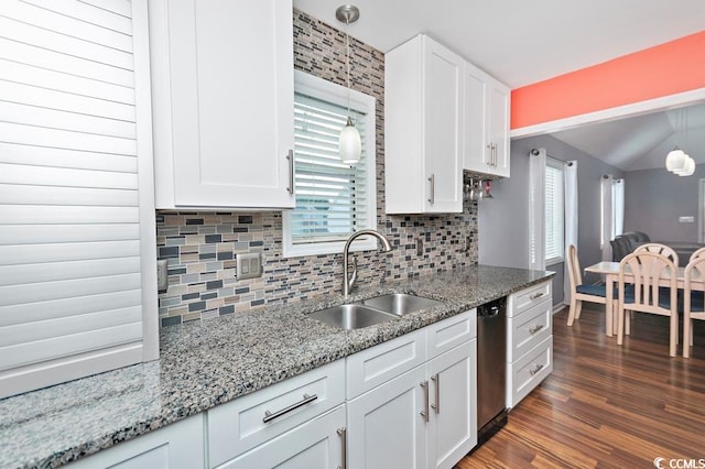 kitchen featuring dark wood-style floors, white cabinets, a sink, and hanging light fixtures