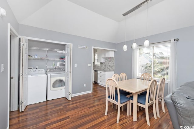 dining area with lofted ceiling, washing machine and dryer, baseboards, and dark wood-style flooring